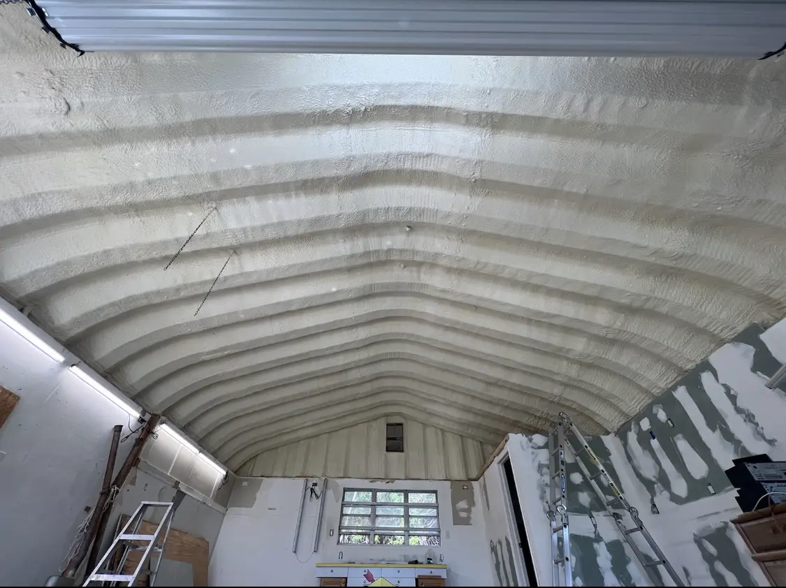 Spray polyurethane foam applied to the underside of a metal roof deck in Tupper Lake